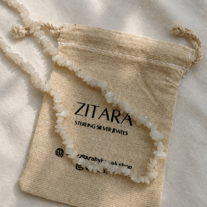 Necklace in a Zitara branded drawstring bag on a light background