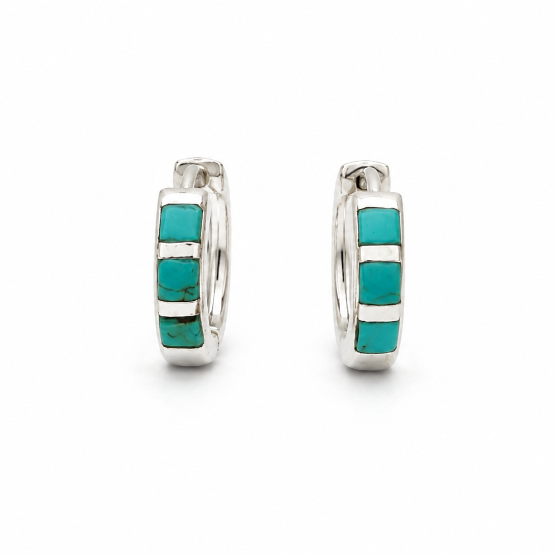 A pair of silver huggie hoop earrings with rectangular turquoise inlays, shown against a plain white background.