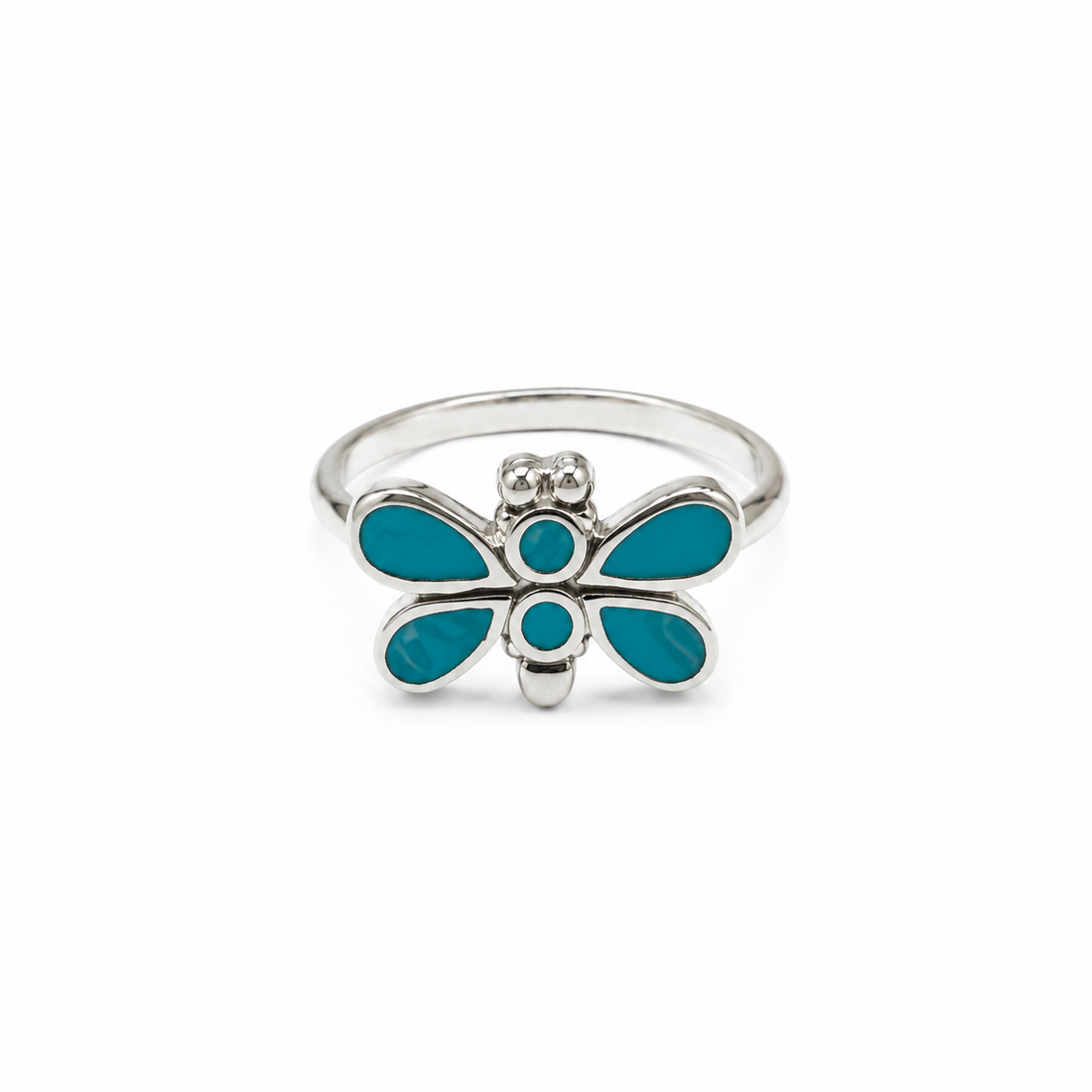 A silver ring shaped like a dragonfly, featuring vibrant turquoise blue enamel inlay on its wings and body, set against a plain white background.