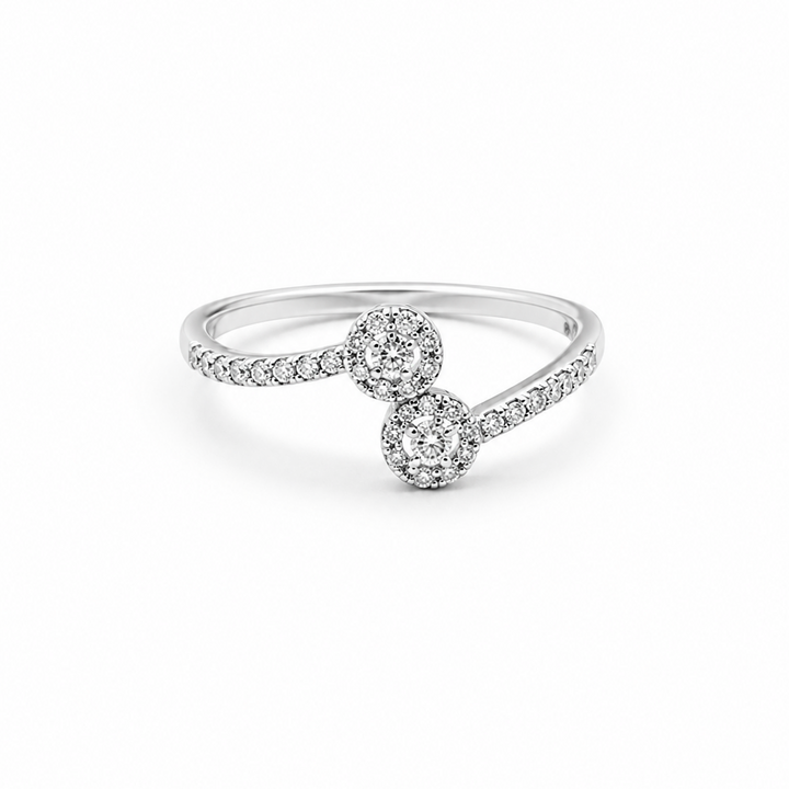 A silver-toned diamond ring featuring two round diamond clusters connected by a pavé-set band, shown on a clean white background.