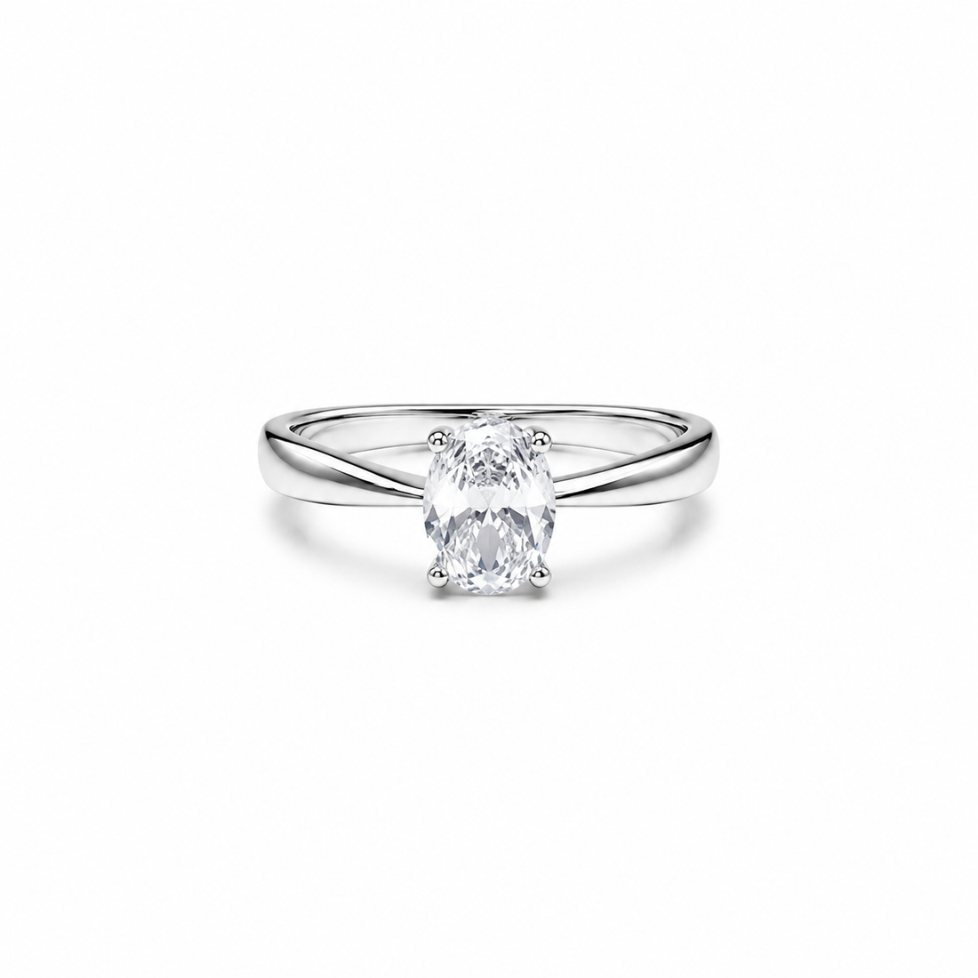 A silver solitaire engagement ring with an oval-cut clear gemstone, set against a seamless white background.