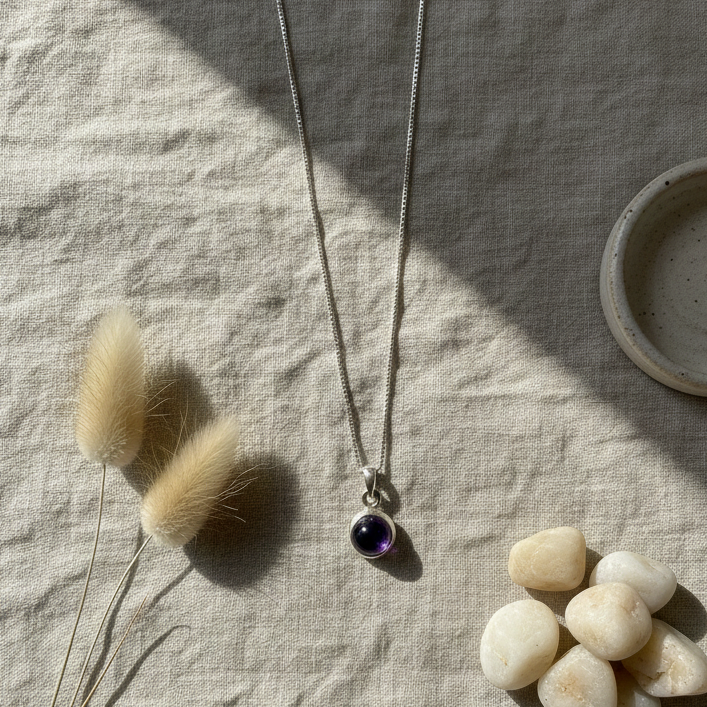 Necklace with a pendant on a textured surface with decorative elements