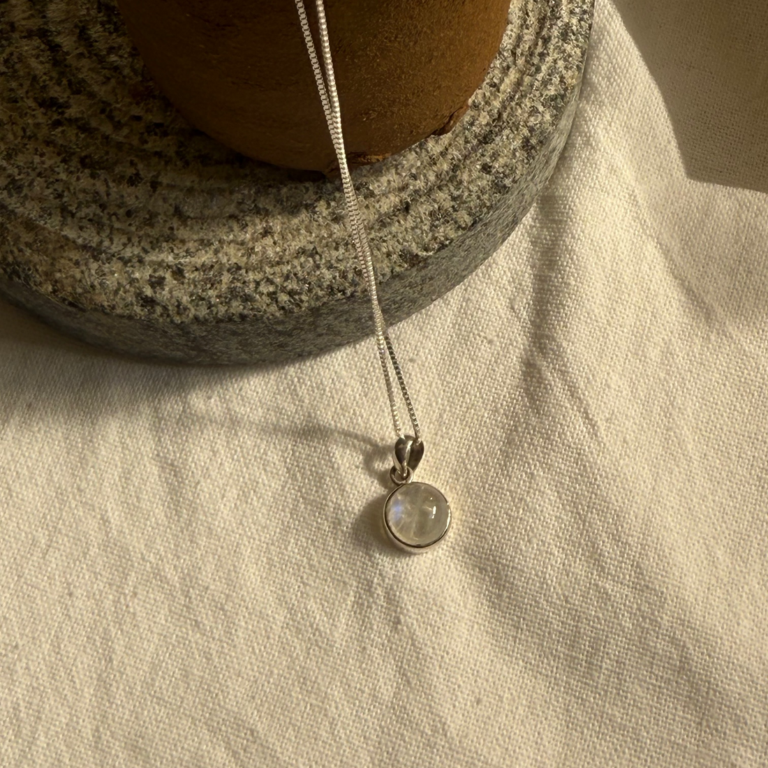 Necklace with a pendant on a textured surface