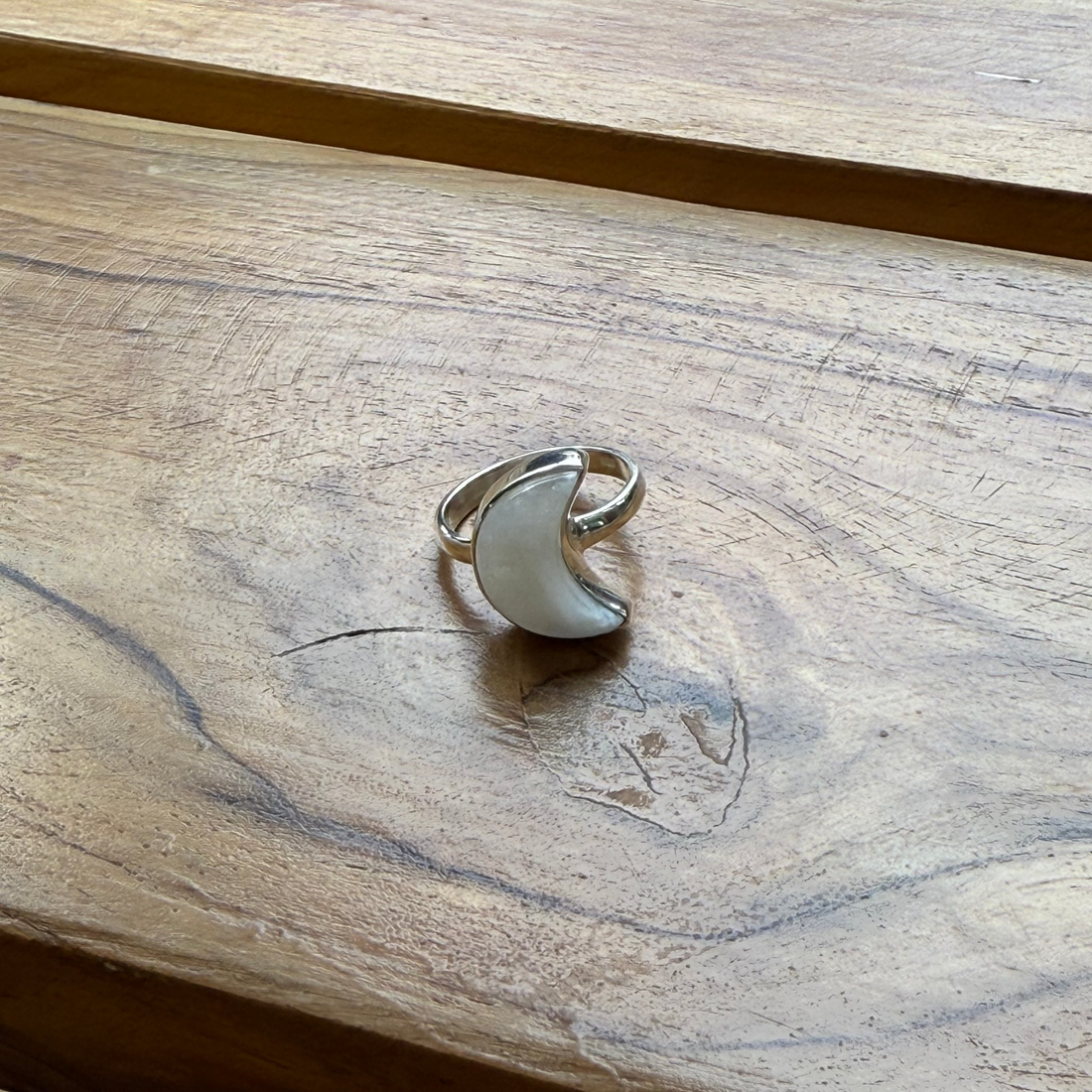 Silver ring on a wooden surface