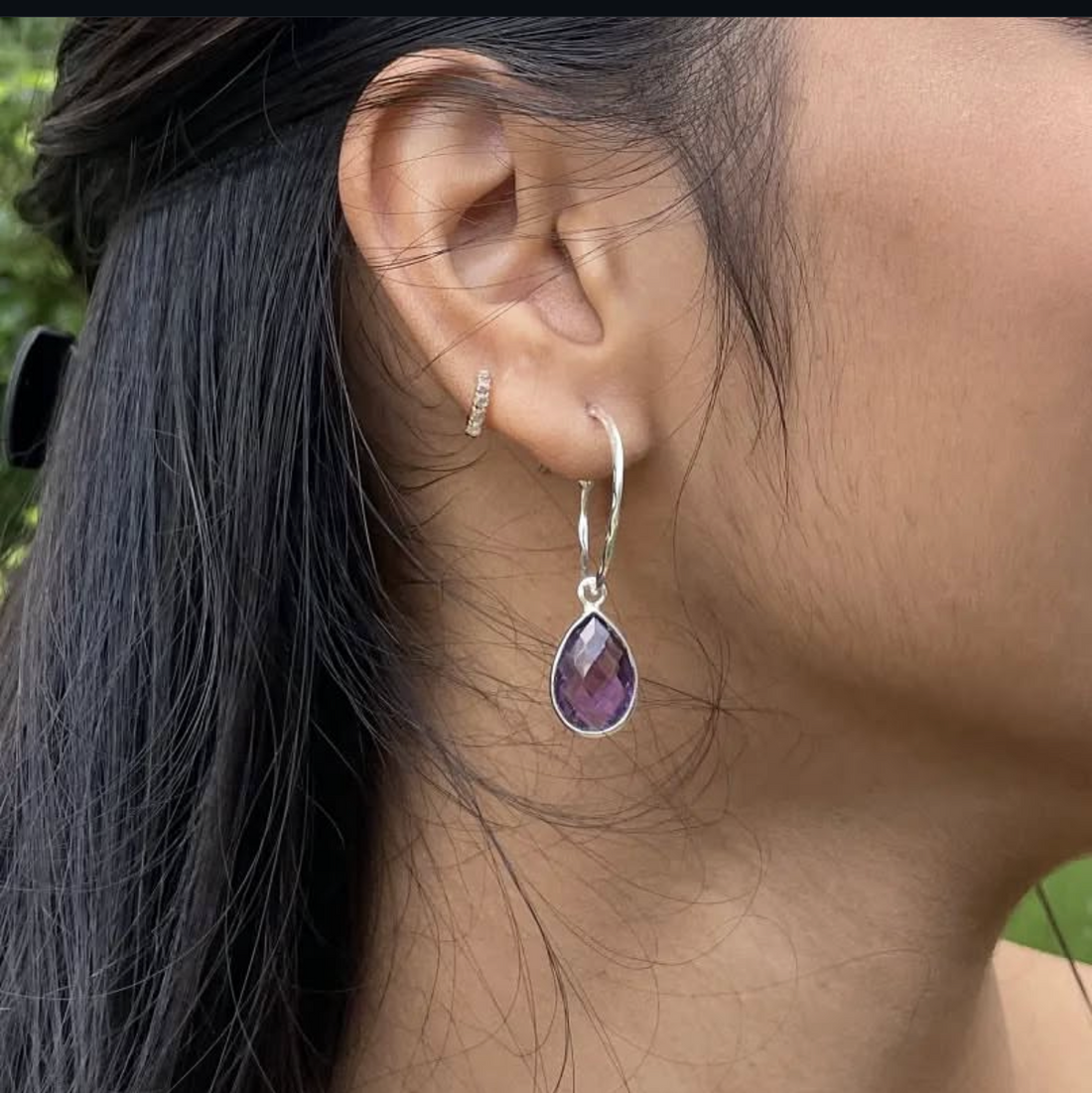 Close-up of an earring worn by a person with dark hair, displayed on a social media platform.