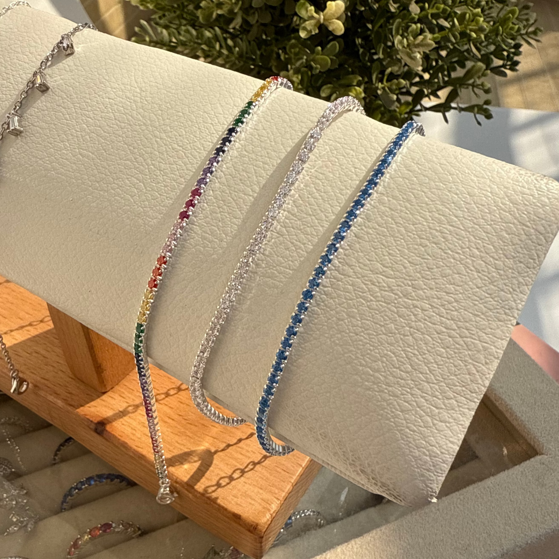 Colorful beaded bracelets on a wooden stand with a neutral background
