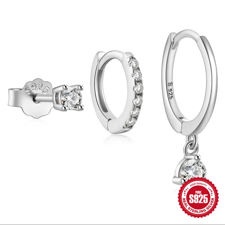 Silver hoop earrings with a pendant on a white background, displayed on a smartphone screen.