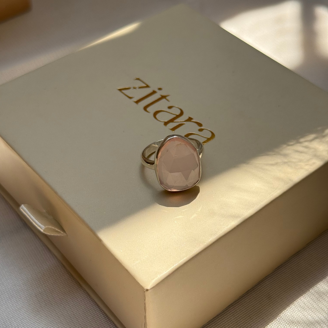 Rose gold ring on a Zitara branded box